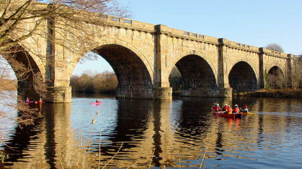 Canoeists paddle under the Lune Aqueduct