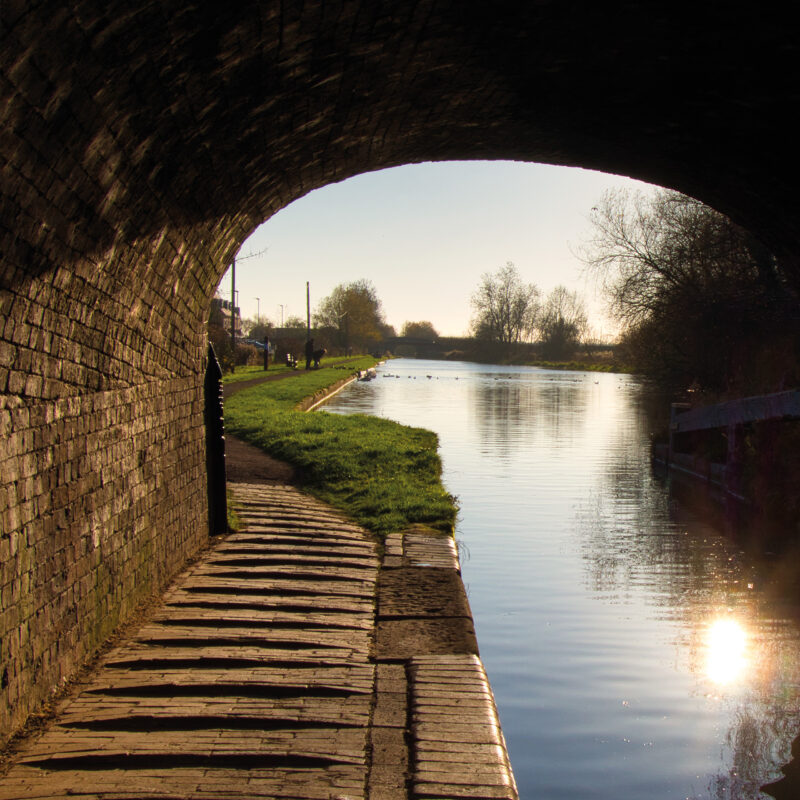 view of a canal through a bridge