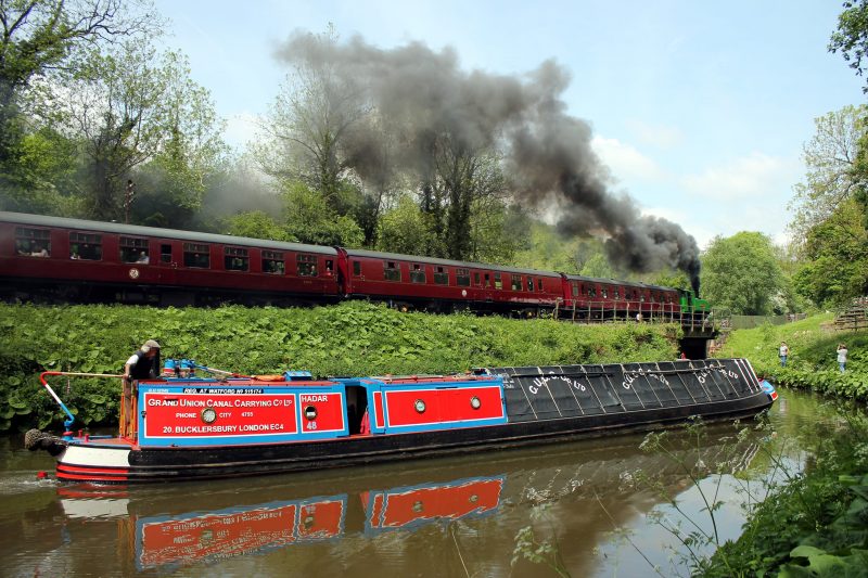 Steam Train passes a Working Narrow Boat on the canal