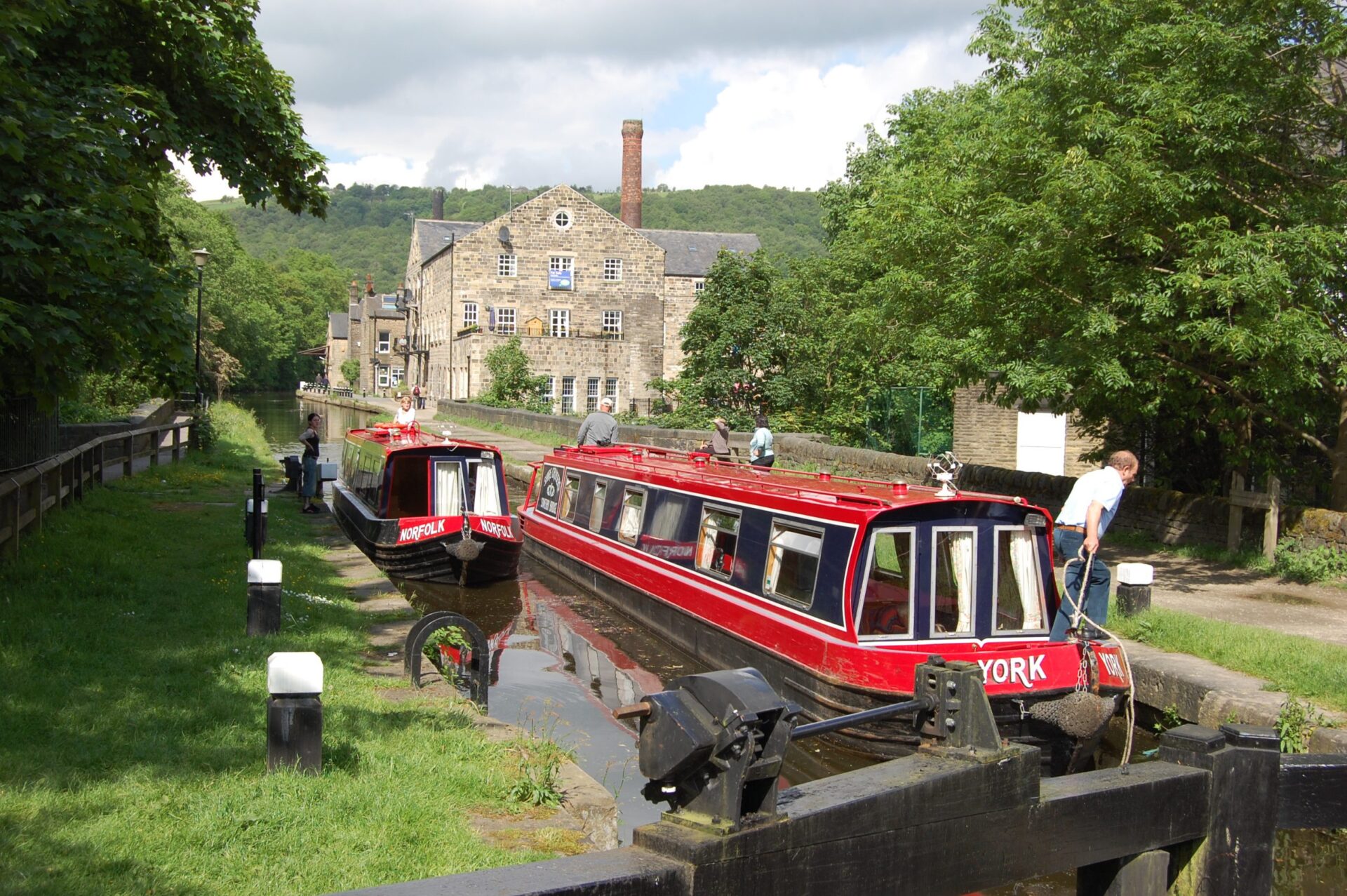 Canal hire boat on canal in front of house