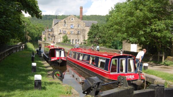 Canal hire boat on canal in front of house