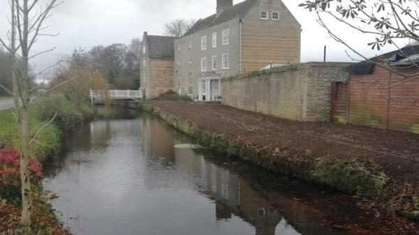 Molecey Mill on the Stamford Canal - featuring the road, canal and mill then behind it the mill-wheel, millstream and river.
