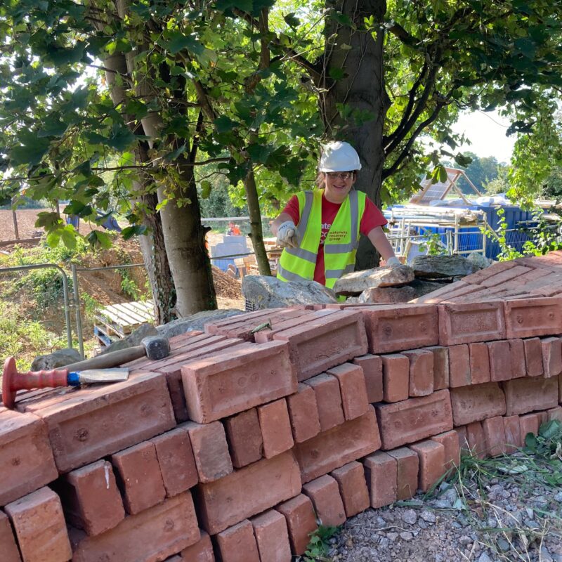 Volunteer with bricks