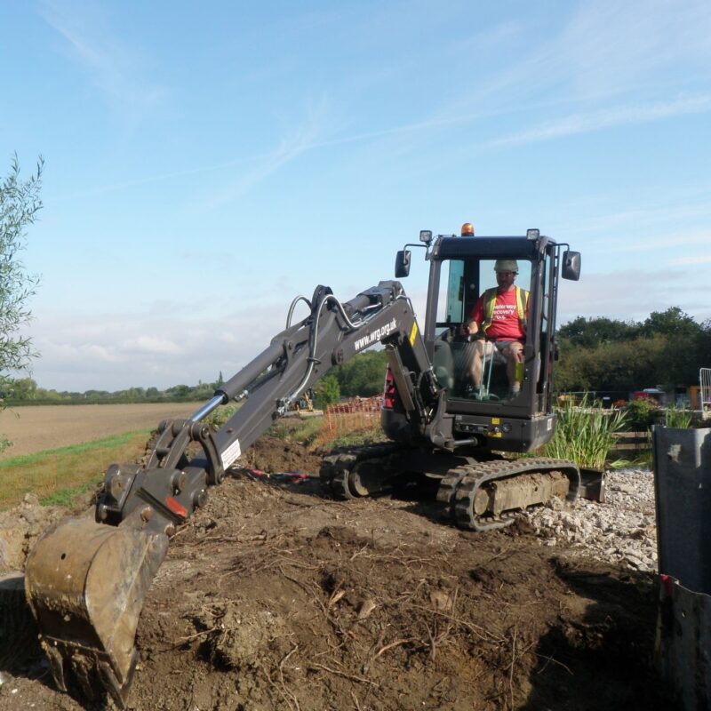 Volunteer in a digger on the Grantham Canal