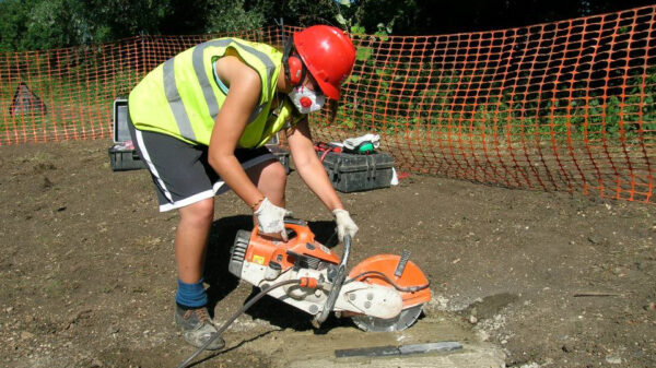 volunteer using bricksaw
