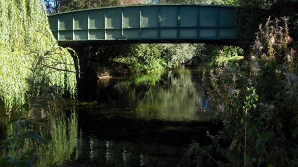 Historic green steel girder bridge over the river